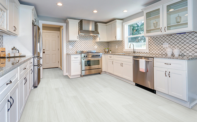 kitchen with white vinyl floors and a patterned backsplash